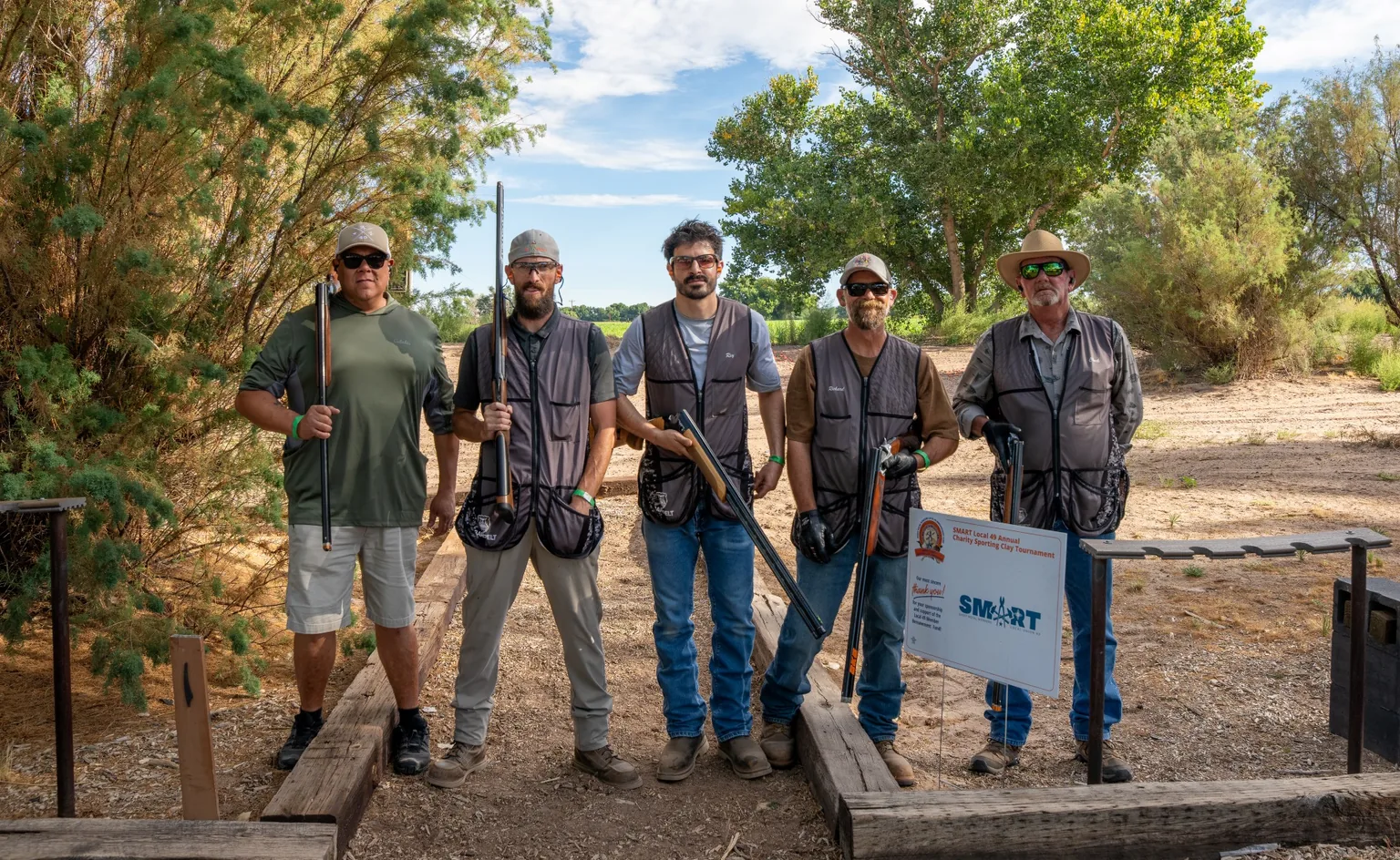 Local 49 members pose together outdoors at the sixth annual charity sporting clay tournament.